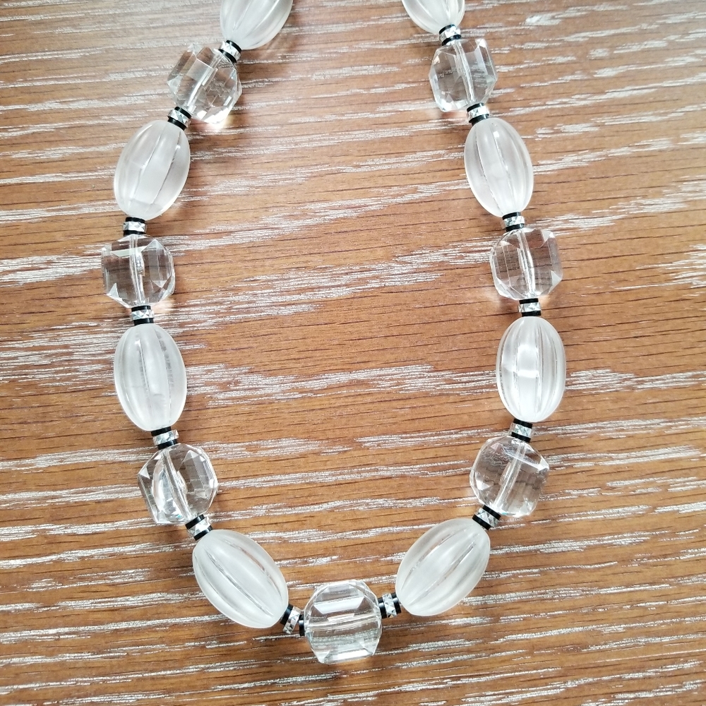 Clear and opaque plastic beaded necklace.
